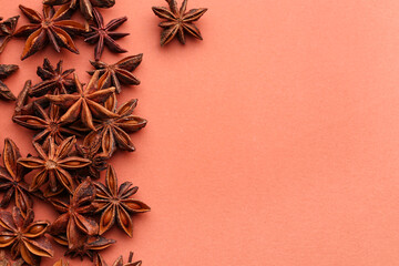 Heap of aromatic star anise on color background