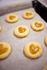 Christmas shortbread Linzer cookies with jam filling close-up  on the table. Vertical