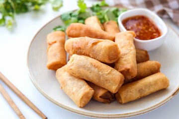 Deep fried vegetable spring rolls or egg rolls and sauce , Thai called popia on white background, vegetarian food	