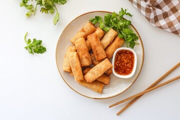 Deep fried vegetable spring rolls or egg rolls and sauce , Thai called popia on white background, vegetarian food