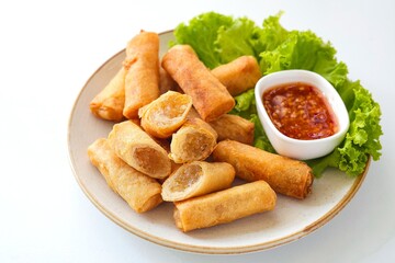 Deep fried vegetable spring rolls or egg rolls and sauce , Thai called popia on white background, vegetarian food