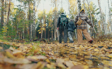 family walking in autumn forest