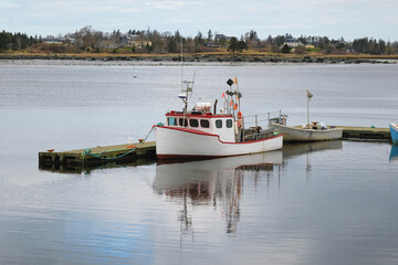 Fishing Boat Docked at the Atlantic Ocean Shoreline in Canada Under Clear Skies