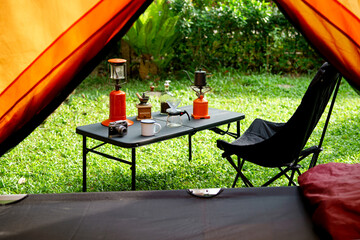Looking out from the inside of the tent to Resting equipment for setting up a camping tent In the...