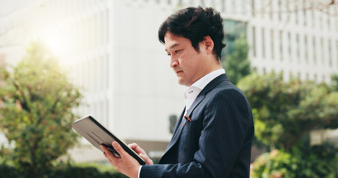 Businessman, reading or tablet in city for news, travel or research for urban development in Osaka. Mature investor, tech or scroll in Japanese town for info, investment opportunity or economy growth