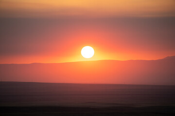 Wonderful red sunset over Mountain West valley Wyoming with red and black clouds haze