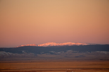 Gorgeous delicate sunset over white mountains in Wyoming 