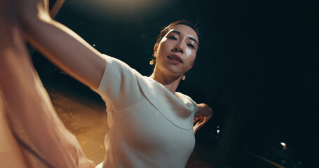 Ballet, performance and portrait with Japanese woman in city for balance, theater and elegant dance. Talent, art and feminine with person or ballerina dancer at night for recital, music or practice © peopleimages.com