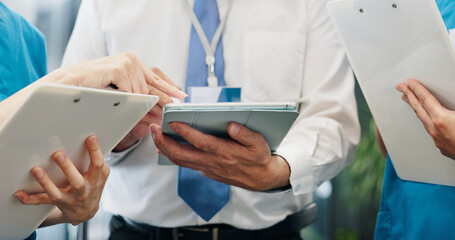 Doctor, nurses and hands for tablet, healthcare and medical collaboration with discussion in...