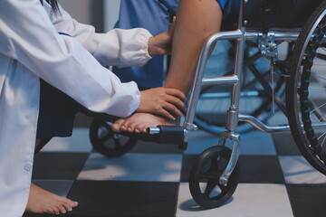 Obraz premium Asian young professional successful friendly female nurse in blue hospital uniform helping supporting physical therapy senior old pensioner unhealthy injury woman patient walking via four legs walker.