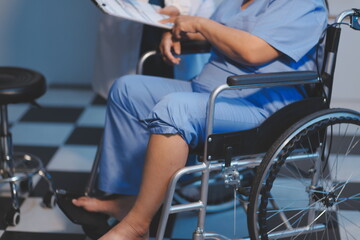 Obraz premium Asian young professional successful friendly female nurse in blue hospital uniform helping supporting physical therapy senior old pensioner unhealthy injury woman patient walking via four legs walker.