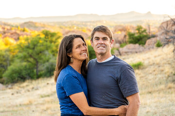 Couples embrace in a serene natural setting during sunset in the countryside of the American...