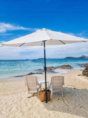 Relaxing under a sunshade on the serene sands of Samae San Island, Thailand