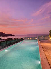 Breathtaking sunset view over the infinity pool on in Thailand