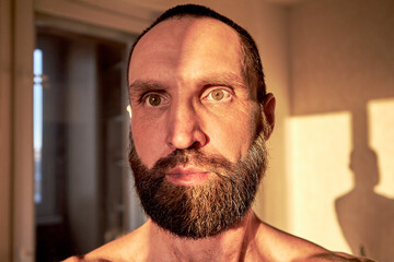 Thoughtful handsome mature man, close-up portrait. The face of a thoughtful, serious man looking away.