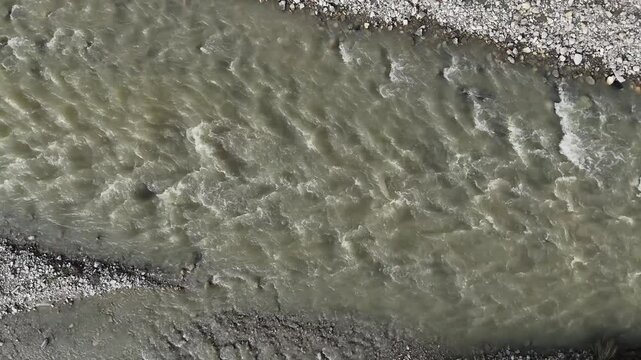 close up of water flowing in the riverbed of Arda River in Val Tolla, Lugagnano D'Arda, Piacenza, Italy, drone overhead panning