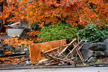 Pile of copper pipe removed from debris of house demolition, rainy day residential construction project job site
