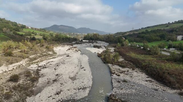 Scenic view of arda river winding through val tolla valley, surrounded by rocks, vegetation, and hills in the autumn season, Mignano, Lugagnano D'Arda, Piacenza, Italy