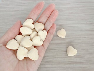 hand holding a heart shaped wood