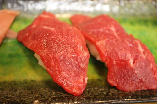 Japanese cuisine: fresh baniku (horse meat) sushi in Tokyo, Japan