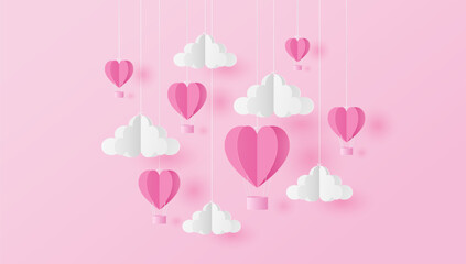 Paper cut of heart shape balloons and clouds on pink background. Valentine's Day concept 