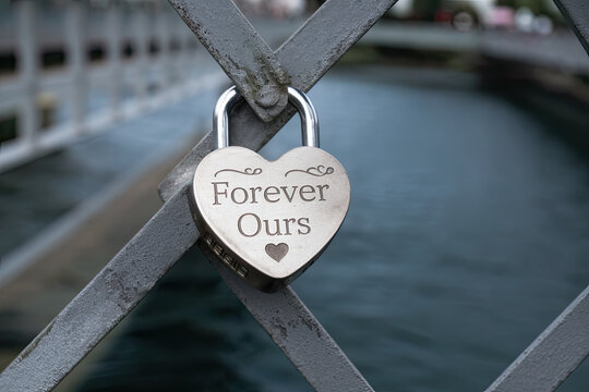 Engraved lock on a love bridge symbolizing eternal commitment