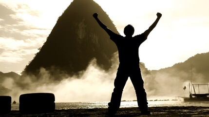 Fototapeta premium of a man lifting his arms in triumph, with fog swirling around a mountain peak in the background.Double Exposure.[men]:[Fog in nature] 