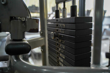 Closeup weight lifting machine at fitness center on blurred background.