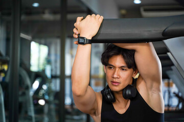 Fototapeta premium Asian handsome sport man acting for a photo in the gym
