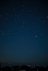 Naklejka premium The night sky is strewn with stars