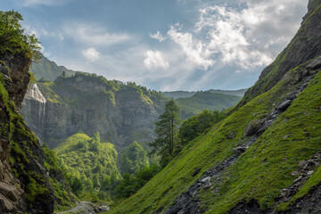 Peaceful mountain trail in majestic Swiss Alps in summer, Batoni Waterfalls valley