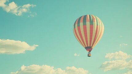Naklejka premium Colorful Hot Air Balloon in a Blue Sky with Clouds
