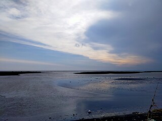 beach atmosphere in the afternoon with big waves and beautiful black sand