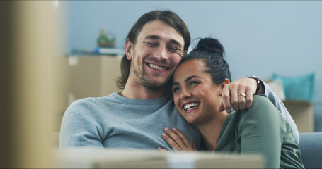 Happy couple, hug and boxes in new home with love, support and pride for investment opportunity. Man, woman and relax on sofa for moving in, relationship milestone and loan approval for apartment