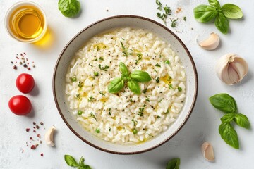 A delicious bowl of creamy risotto garnished with fresh basil, surrounded by tomatoes and garlic.