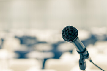 Microphone voice speaker in seminar classroom, lecture hall, town hall meeting or conference forum in educational business event for coaching host or teacher with audiences or students seats