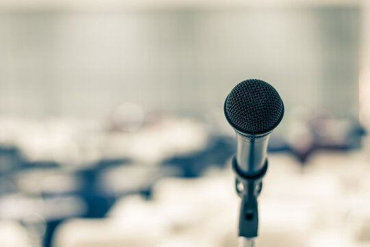 Microphone voice speaker in seminar classroom, lecture hall, town hall meeting or conference forum in educational business event for coaching host or teacher with audiences or students seats