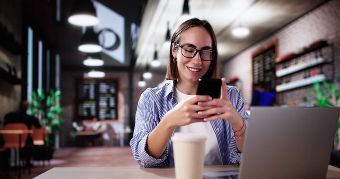 Student Using Phone And Laptop