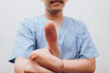cropped image of a male doctor showing his thumbs up