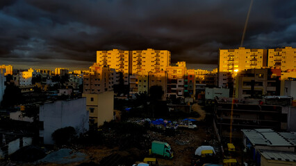 Orange light of setting sun illuminating the skyscrapers and high-rise buildings in Bangalore, India.