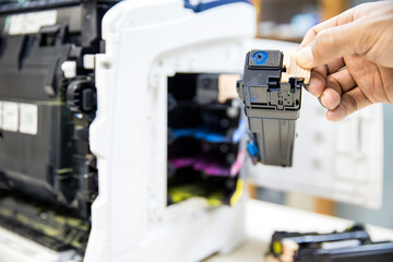 Technician Holding ink printer toner low for replace new or fix repair problem paper or print scanning fax or copy document or photocopier or photocopy office workplace equipment concept