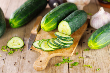 sliced cucumbers on wooden cutting board