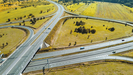 Traffic on highway through dense forest