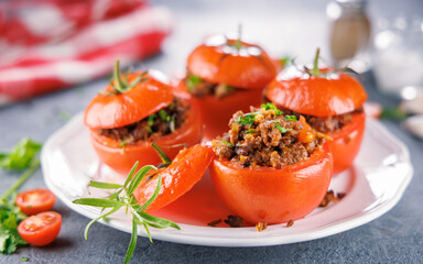 stuffed baked tomato with beef on plate