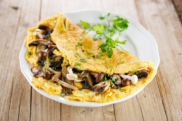 fluffy omelet with mushrooms on plate