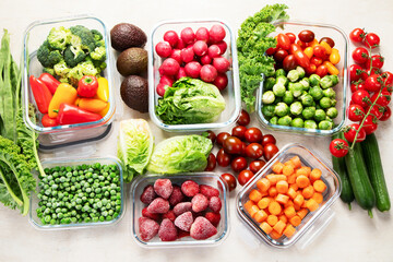 Boxes with fresh raw vegetables on table.