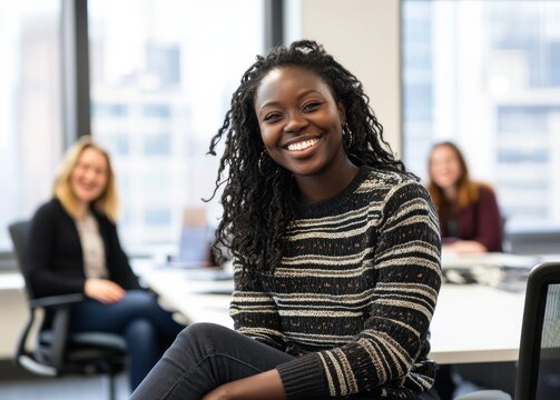 A diverse group of professionals laughing and sharing ideas during an office meeting. - Powered by Adobe