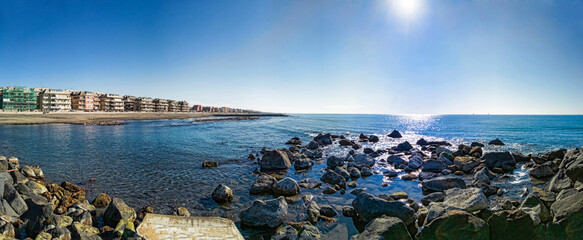 Panoramic view at sunny winter weather at Roma shoreline, calm sea and city skyline