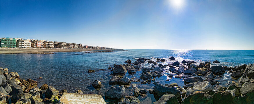Panoramic view at sunny winter weather at Roma shoreline, calm sea and city skyline
