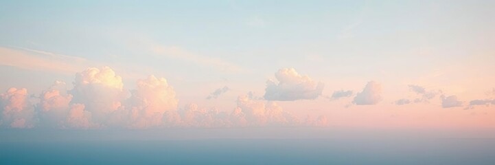 Wide open sky with fluffy white clouds stretching across the horizon gentle blue shade fading into light pink hues at sunset, soft focus, blue sky, clouds